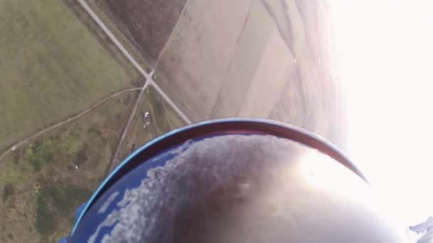 Skydiver parachuting in sky over green fields. Extreme activity. Adrenaline — Stock Video