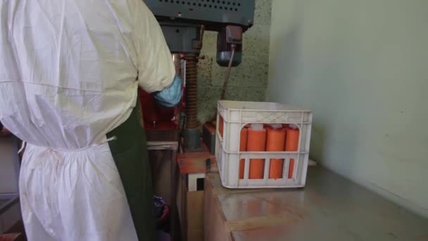 Lab operator in uniform takes orange plastic tubes out of of rotating machine — 비디오