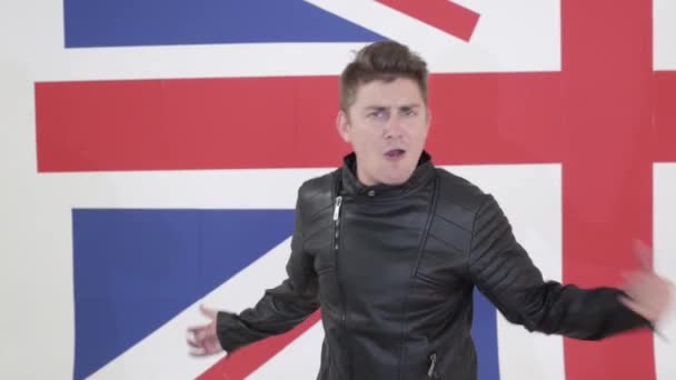 Cute blue eyed male in leather motorcycle jacket actively sings and dances. — Stock Video
