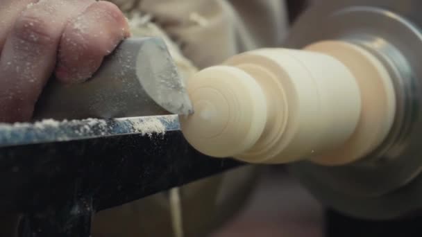 Manos de carpintero de cámara lenta cortando la perilla pieza de madera girando en la máquina — Vídeo de stock