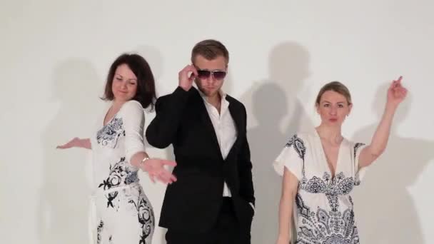 Company of dancing cute females and nice-looking male in suit and sunglasses — Stock Video