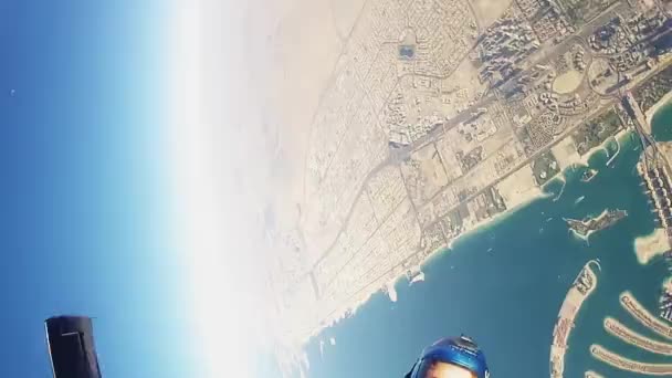 DUBAI, EMIRATOS ÁRABES UNIDOS - 15 DE FEBRERO DE 2014: Paracaidista profesional salta desde un avión en el cielo azul. Hacer formación por encima de Dubai — Vídeos de Stock
