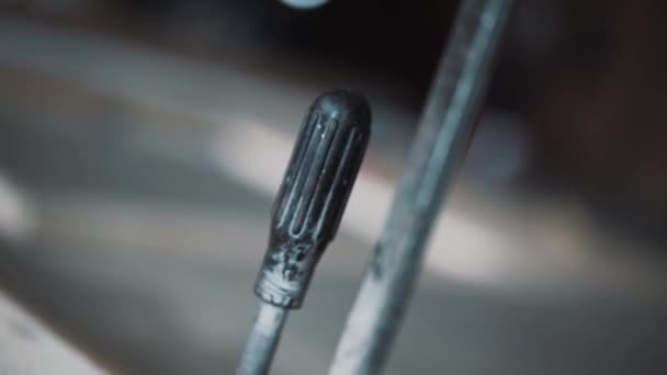 Closeup μαύρο μεταλλικό εργαλείο που συνδέεται με την κίτρινη ξύλινη σανίδα στο πτωχοκομείο. — Αρχείο Βίντεο