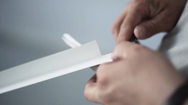 Mans elele beyaz plastik, makas ve inşaat bıçak parçası