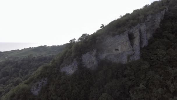 Quadcopter shows green hill with cave , Black Sea, Abkhazian shorecost — Stock Video