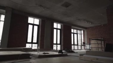 Büyük siyah çerçeveli pencereler, katta ve iskele plakalar ile karanlık büyük salonu