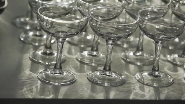 Rows of beautiful coctail glasses put on large grey table. — Stock Video