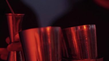 Siyah giyen garson shaker gece kulübü, bar içinde meşrubat hazırlanıyor.