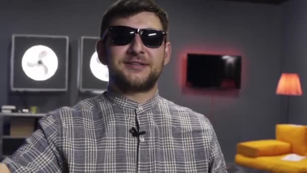 Cute guy blogger holds big gold bitcoin in hand and looks at camera with smile. — Stock Video