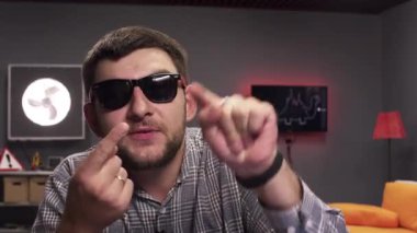 Sakallı komik esmer adam görüşmeler ve aktif modern döşenmiş odada alkışlar.