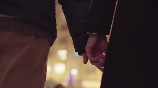 Two gay males are holding hands standing outside in cold winter street — Stock Video