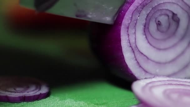 在绿色厨房餐桌上用锋利的刀将洋葱切成戒指的视图. — 图库视频影像
