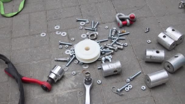 Instruments, different spare parts and construction stuff are strewn on ground. — Stock Video