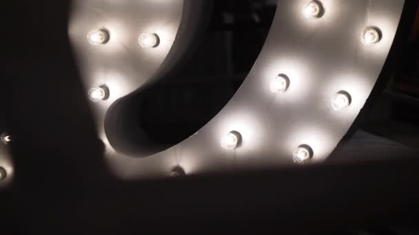 Plenty of white lightbulbs are mounted to part of arch shaped grey structure. — Stock Video