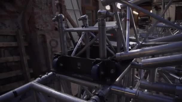 Framework of concert stage aluminium structure placed outside next to old house — Stock Video