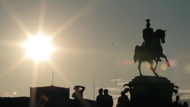 Silhouetten von Denkmälern, Menschengruppe darunter und Extrembiker. — Stockvideo