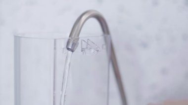 Kahve makinesinin büyük Plastik Konteyner mutfakta musluk suyu ile doldurulur.