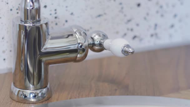 Persons hand is touching tap water faucet to open it so water could flow. — Stock Video