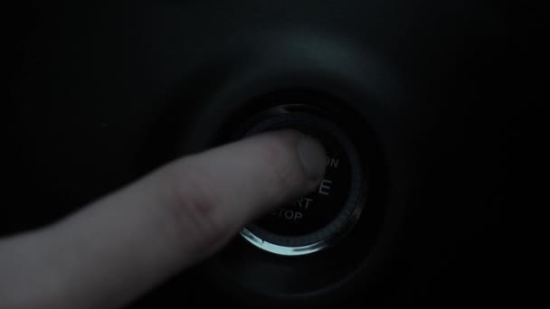 Macro view of male drivers hand is pressing engine start button to turn it on. — Stock Video