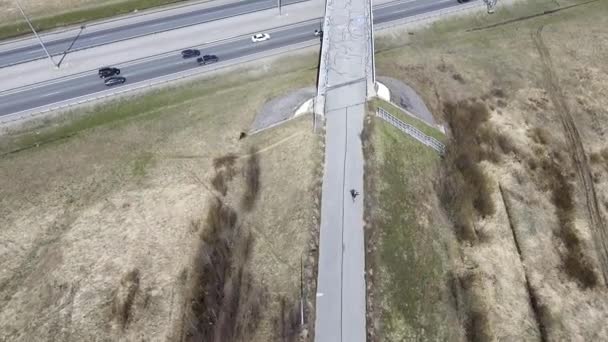 Spectacular aerial view of grey roads, buildings, rooftops, bridges and fields. — Stock Video