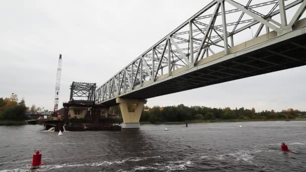 Αγία Πετρούπολη, Ρωσία-20 Σεπτεμβρίου, 2018: ποταμός σκοτεινής κλίμακας με γεφύρι και οικοδομικές περιοχές με σκυρόδεμα και γερανοί — Αρχείο Βίντεο