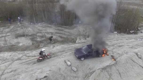 Vista superior del coche en llamas en el campo de polvo desierto con humo negro que sube al cielo — Vídeo de stock