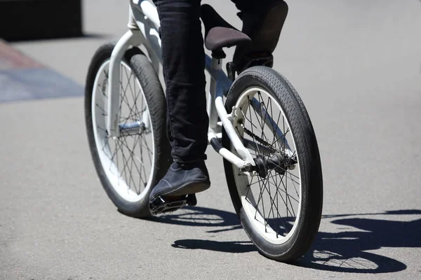 the urban cyclist in motion on the sidewalk