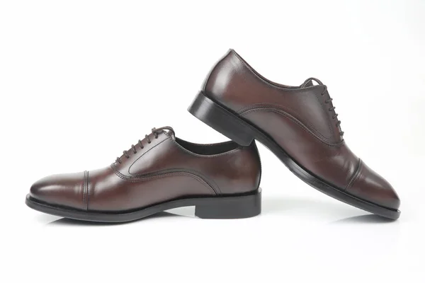 Classic men's brown Oxford shoes on white background. Leather shoe