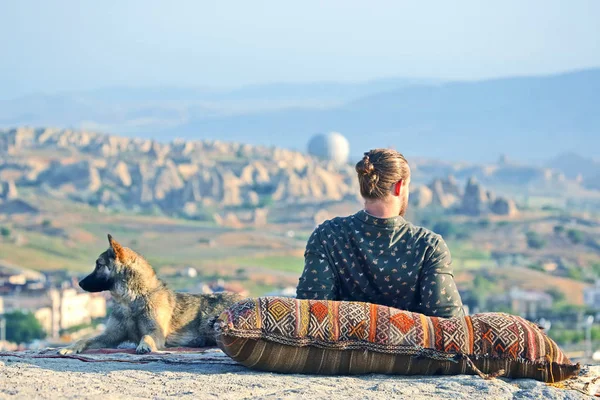 man with a dog watching the beauty of nature in Cappadocia. Turkey