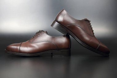 Koyu arkaplanda klasik erkek kahverengi Oxford ayakkabıları.
