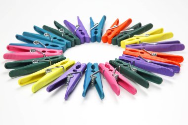 Beyaz bir arka plan üzerinde elbise renkli clothespins dönüştürün