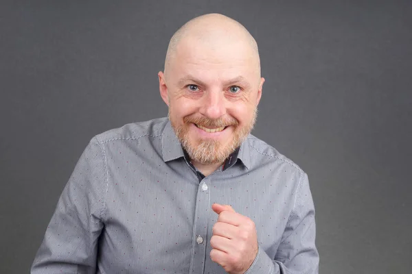 Portrait of a bald and bearded happy man