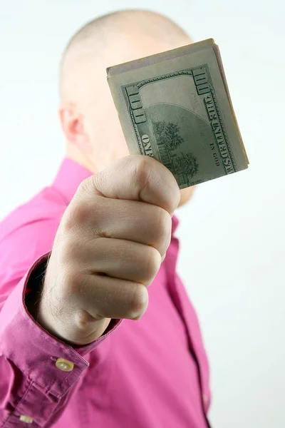 Man holds out his hand with money — Stock Photo, Image