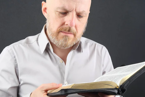 man ponders reading a Bible book