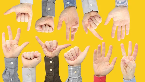 Various gestures of male hands between each other on a yellow ba — Stock Photo, Image