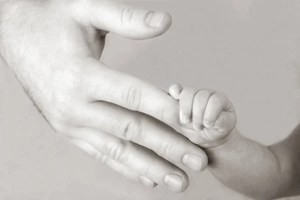 Newborn baby holding his hand on the fingers of parents — Stock Photo, Image