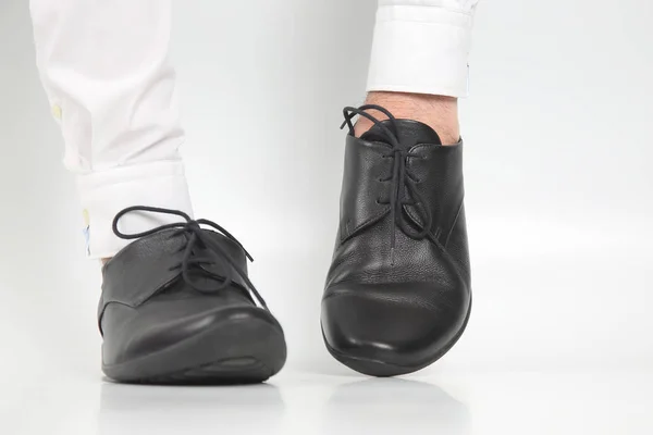 Classic shoes worn on the hands on a white background — Stock Photo, Image