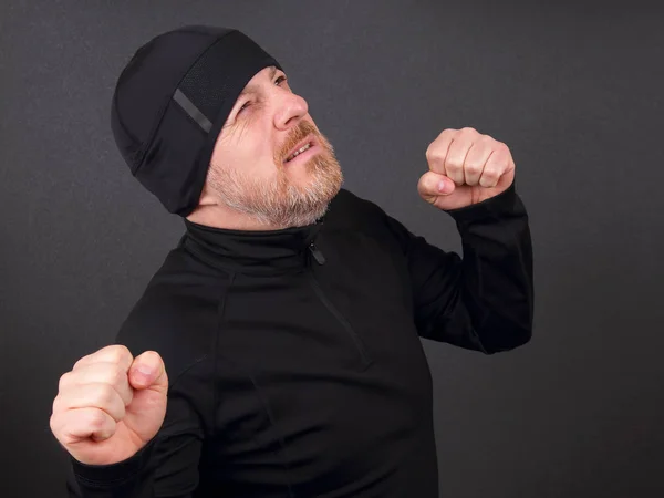 Emotional bearded man with clenched hands in pursuit of victory — Stock Photo, Image