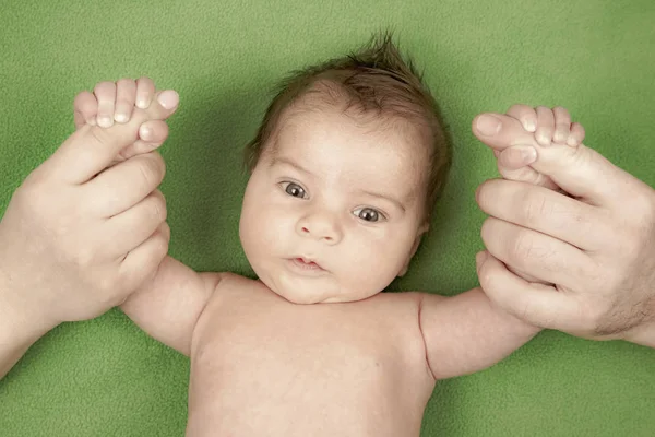 Bebê recém-nascido feliz de mãos dadas de seus pais — Fotografia de Stock