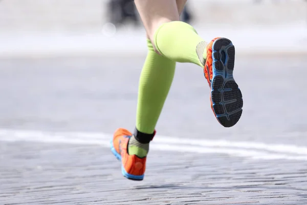 feet running distance athlete on the stone pavement