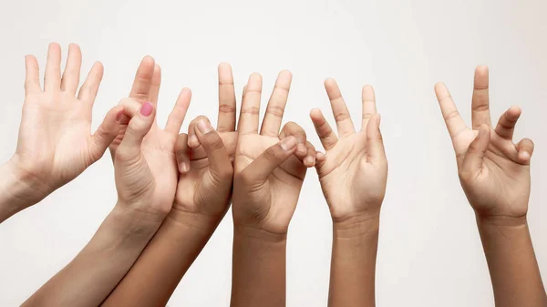 Many raised children's expressive hands in a ro — Stock Photo, Image