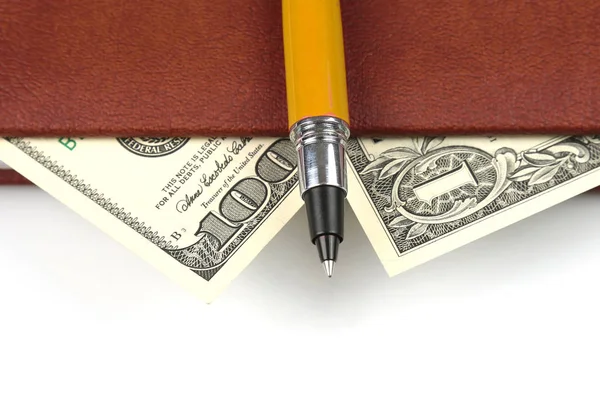 banknotes and a red pen lying inside the notebook