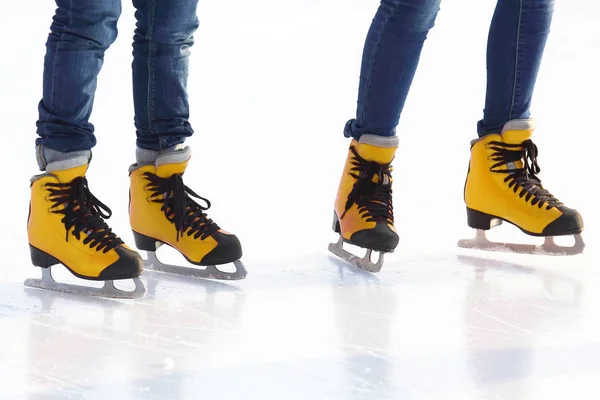 feet in skates on an ice rink. Hobbies and recreation. Sports an