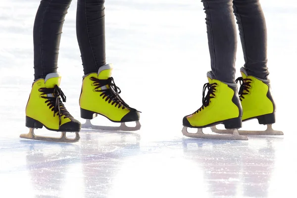 feet in skates on an ice rink. Hobbies and recreation. Sports an
