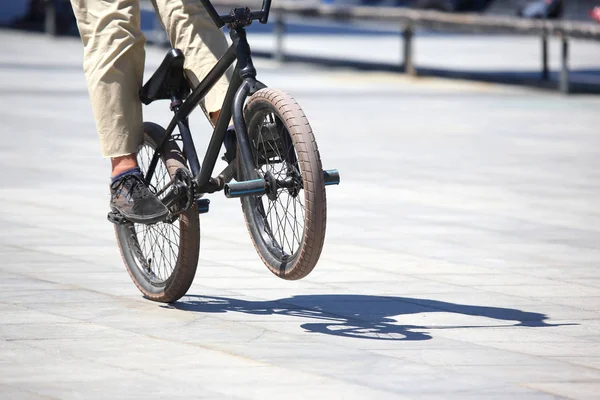 the urban cyclist in motion on the sidewalk