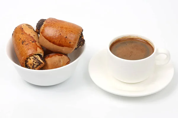 rolls with poppy seeds and white Cup of black coffe