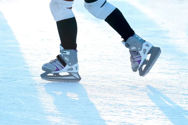 Feet rolling on skates man on the ice rink — Stock Photo, Image