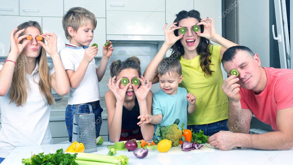 family with children having fun over cooking