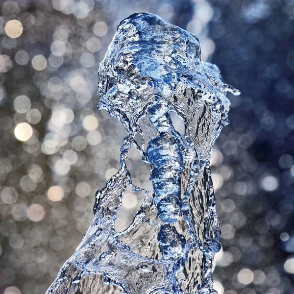 Drops water of the fountain. Abstraction and blurring in the pla — Stock Photo, Image