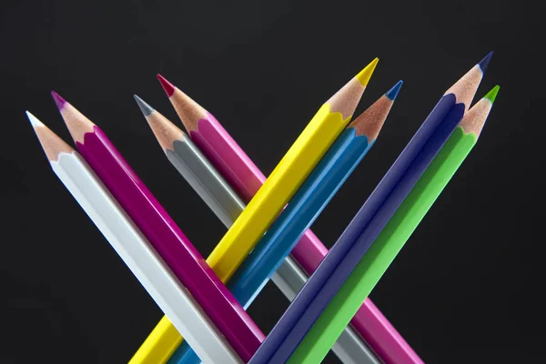 Colored pencils on a dark background. Education and creativity. — Stockfoto